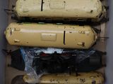 a box with a bunch of yellow cylinders in it