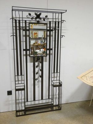 a metal shelf with a mirror and a umbrella on it