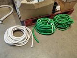 many hoses that are sitting on the floor next to boxes