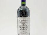 a bottle of wine sitting on top of a white table