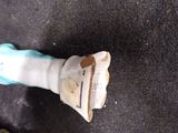 a broken toothbrush sitting on the floor next to a bag
