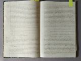 an open book with yellow sticky notes sitting on top of a table
