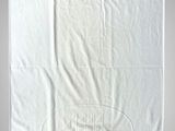 a white towel with a logo on it hanging on a wall