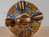 a wooden object on a table with a blue and orange design