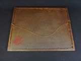 an old brown leather envelope sitting on top of a black table