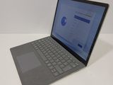 a laptop that is sitting on a white table