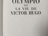an open book with a picture of the olympic logo on it