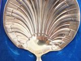 a silver spoon in a blue box on a table