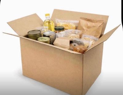 a cardboard box filled with food and condiments