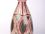 a vase that is sitting on a white surface