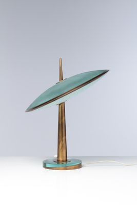 a green lamp that is on top of a table