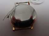 a close up of a watch with a tag on it