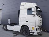 a large white truck parked in front of a building