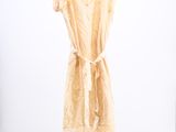 an image of a dress hanging on a hanger in a room