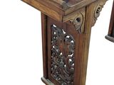 an image of a wooden table with carvings on the top