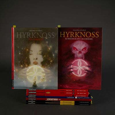 three books are stacked on top of each other on a table