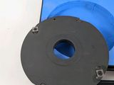 une boîte bleue surmontée d'un disque noir