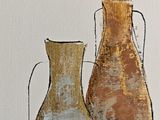 two vases that are sitting next to each other on a table