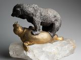 a statue of a bear and a turtle on a rock
