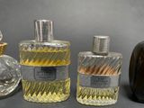 three bottles of perfume sitting next to each other on a table