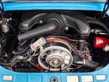 the engine of a small blue car with its hood open