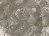 a pile of clear glass pieces on a tiled floor