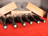several bottles of wine are lined up in a row on a table