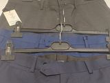 three pairs of pants hanging on a hanger