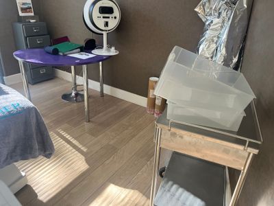 a room with a bed, a desk and a chair in it