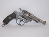 a silver revolver on a white surface with a white background