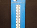 un thermomètre bleu posé sur une table