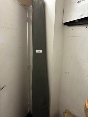 a surfboard leaning up against a wall in a small room