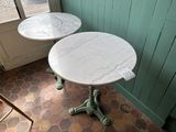 two tables that are sitting on a tiled floor