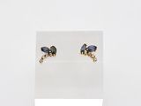 pair of blue and gold earrings on display on a white surface