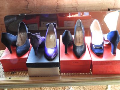 several pairs of women ' s shoes are on display in a display case