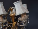 a gold chandelier with three lamps on it
