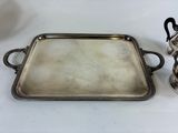 an antique silver tray with handles and handles on a white table