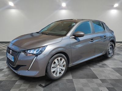 a gray car is parked on a checkered floor in a garage
