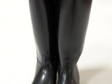 a pair of black boots sitting on top of a white surface