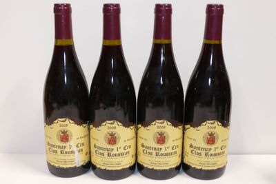 quatre bouteilles de vin sont alignées sur une table