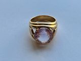 an image of a gold ring with a pink stone in it