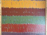 painting of multicolored stripes in a wooden frame on a wall