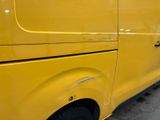 a yellow van that is parked in a parking lot
