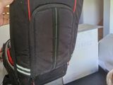 a backpack that is sitting on a table next to a bed