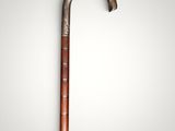 an old cane with a wooden handle on a white background