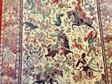 an oriental rug on a wooden floor with a red border