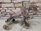 a wooden toy horse that is sitting on top of a cart