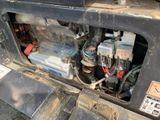 a close up of a vehicle ' s engine with a lot of wires