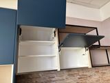 a bed with a pull out bed in the middle of a room