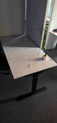 a desk with a chair and a lamp in a room